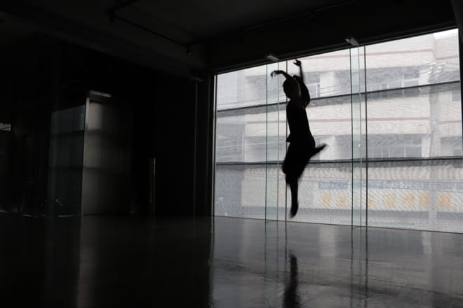 woman dancing in a almost dark floor of a revitalized lift factory