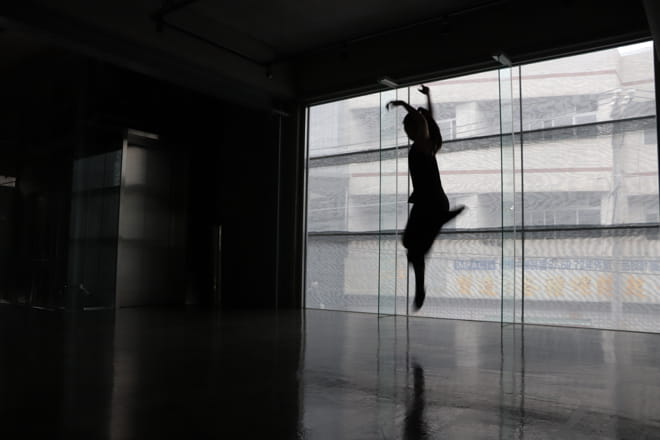 Architektur: woman dancing in a almost dark floor of a revitalized lift factory